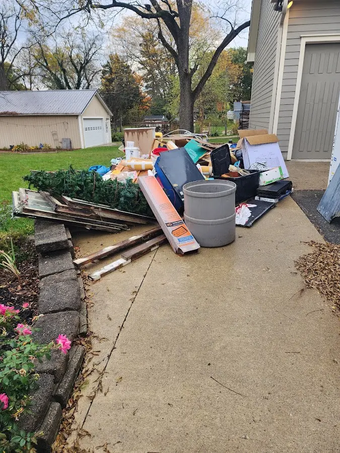 Dumpster being loaded with debris for 12 Yard Dumpster Rental in Northfield